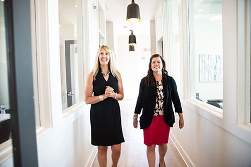 Rebekah Baker and Courtney Lundquist tour the leasing office of The Mezzanine at Freedom.